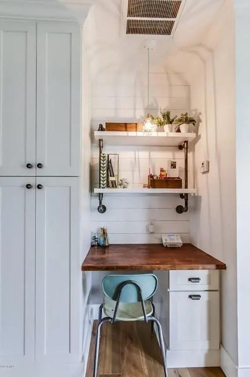 a farmhouse awkward nook done with white shiplap, a built in desk, built in shelves, a pendant lamp and potted greenery for working
