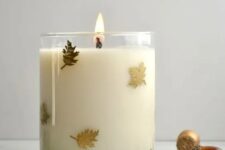 02 a glass candle with tiny gold leaves attached on the outside is a beautiful fall and Thanksgiving decor idea