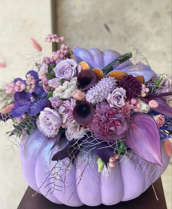 a lilac pumpkin with lilac, mauve, deep purple blooms, greenery and berries will be a great Thanksgiving centerpiece