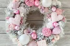 03 a beautiful pastel pink and silver Christmas wreath with hearts, ornaments, snowy pinecones, fluffs and yarn balls is amazing