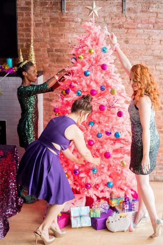 a bold pink Christmas tree with colorful ornaments and a star topper plus lights is awesome for a girls' party