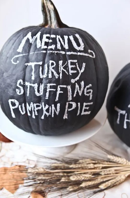 a chalkboard pumpkin can be used as a Thanksgiving party menu or you can chalk something else on it