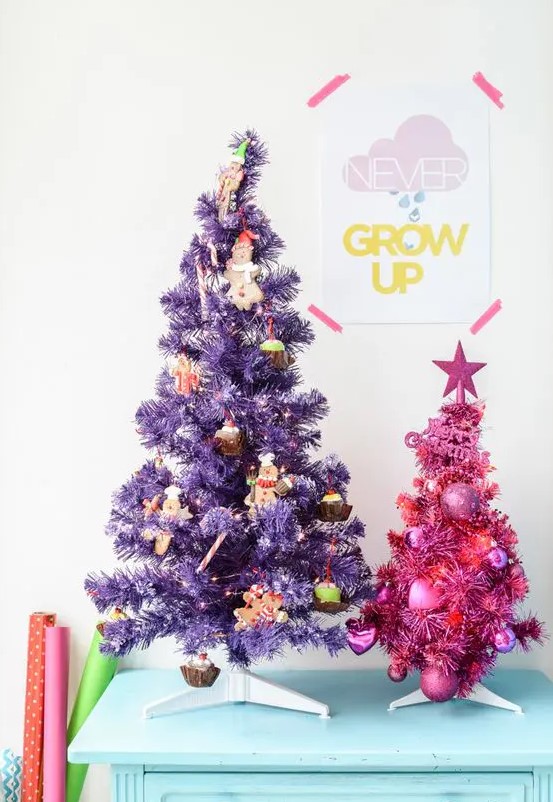 a duo of pretty Christmas trees - a purple and a pink one, with food-themed ornaments and heart-shaped ones
