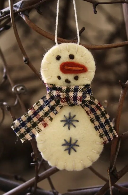 a felt snowman Christmas ornament with embroidery and a plaid scarf is a lovely idea that can be easily DIYed