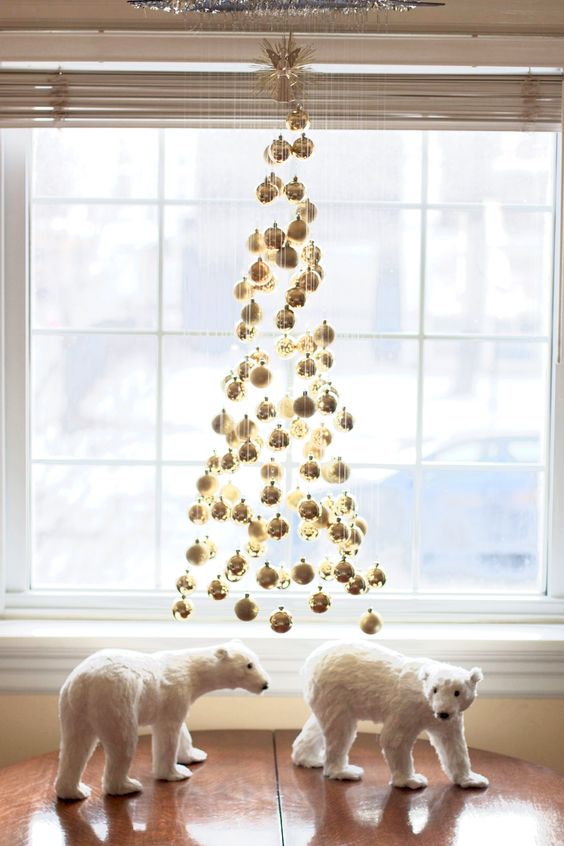 a floating Christmas tree made of gold ornaments is a stylish and super glam decor idea for holidays