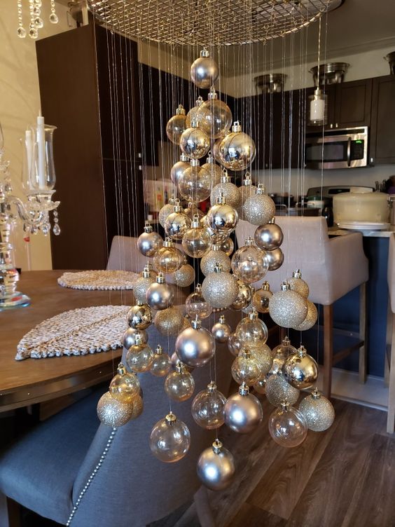 a floating Christmas tree made of silver, glitter and clear ornaments is a stylish and modern alternative to a usual Christmas tree