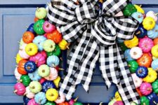 06 a super colorful mini pumpkin wreath with gilded stems and a black and white plaid bow on top is amazing for the fall