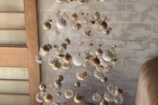 07 a floating Christmas tree of white, clear, gold ornaments is a beautiful solution for a modern space