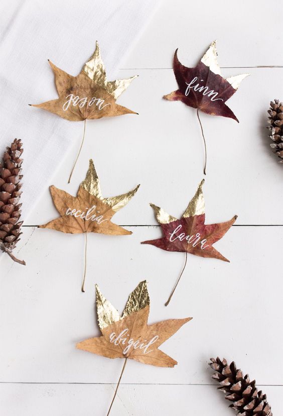 fall leaves with gilded parts and white calligraphy are great for decorating your space for fall and Thanksgiving