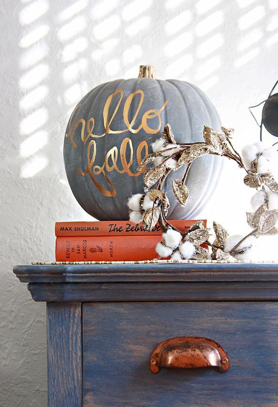 a matte grey pumpkin decorated with gold calligraphy is a chic and cool modern decor idea for Thanksgiving