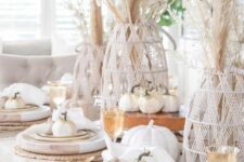 09 a cool rustic meets boho Thanksgiving tablescape with pampas grass in yarn covered vases, white faux pumpkins, large wooden chargers and woven placemats
