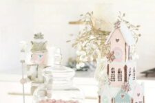 10 a pastel sweets table with pink and blue houses, pink candies in jars and touches of gold for a shiny look