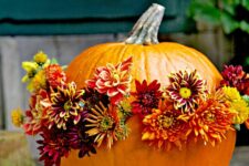10 an orange pumpkin with bright burgundy, ornage and red blooms is a gorgeous all-natural decor idea for the fall or Thanksgiving