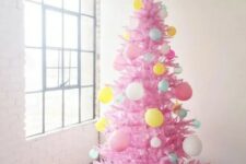 11 a hot pink Christmas tree decorated with balloons of various colors is a super fun and bold idea for celebrating