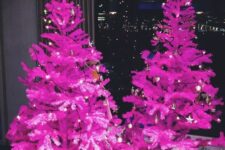 13 a duo of hot pink Christmas trees decorated with only lights is a fantastic idea for a modenr or minimalist holiday space