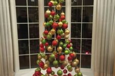 13 a suspended Christmas tree of ornaments in traditional Christmas colors, green, red and gold is a fun idea