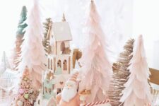 13 whimsical pastel Christmas tablescape with blush paper Christmas trees, gingerbread houses, gnomes and candies and sweets