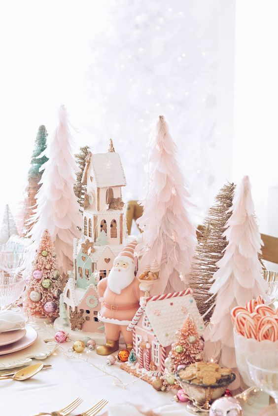 whimsical pastel Christmas tablescape with blush paper Christmas trees, gingerbread houses, gnomes and candies and sweets
