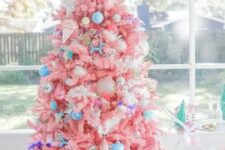 14 a bright candy-colored Christmas tree with bold blue ornaments, ice cream and popsicle ornaments and a candy topper