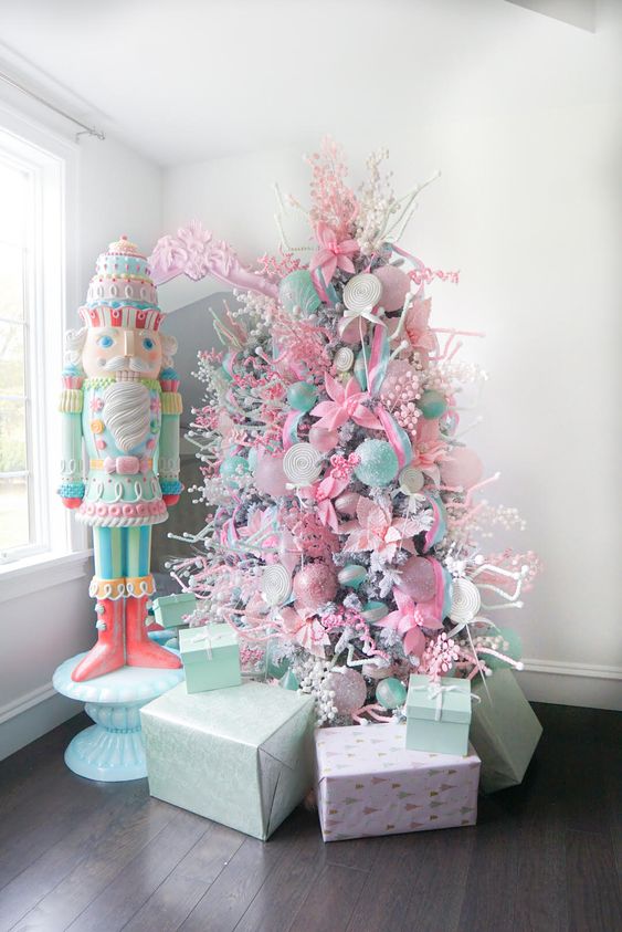 a candy-colored Christmas tree decorated with pastel pink and green ornaments and ribbons of various kinds and looks