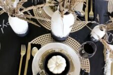15 a chic black and gold Thanksgiving tablescape with a dark runner, napkins, plywood placemats, wheat in a vase and gold cutlery