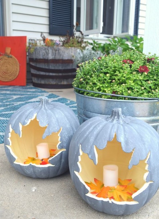 candle lanterns carved of faux pumpkins with leaves inside are great for decorating your home both indoors and outdoors