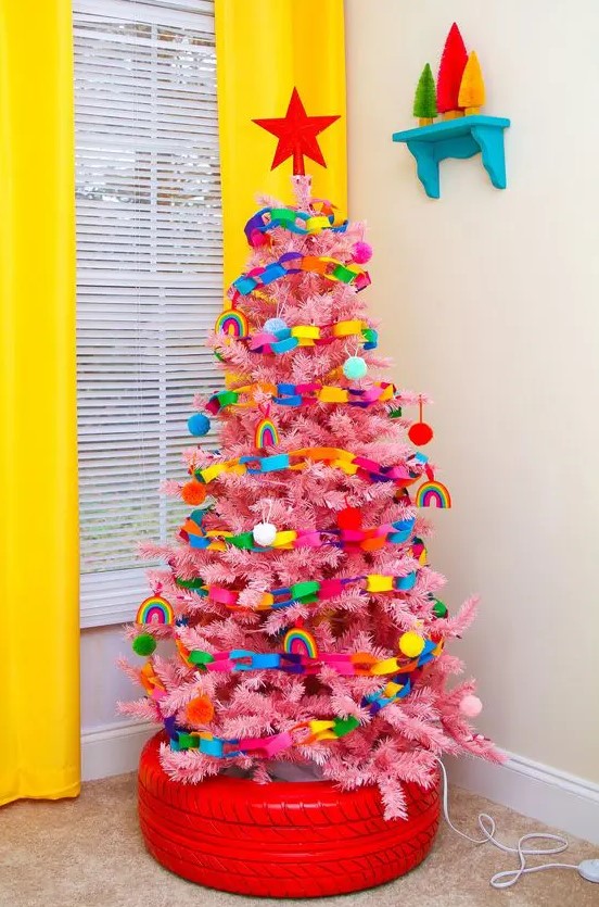 a pink Christmas tree decorated with super bold ornaments and chains of paper is a bold idea for a kids' space
