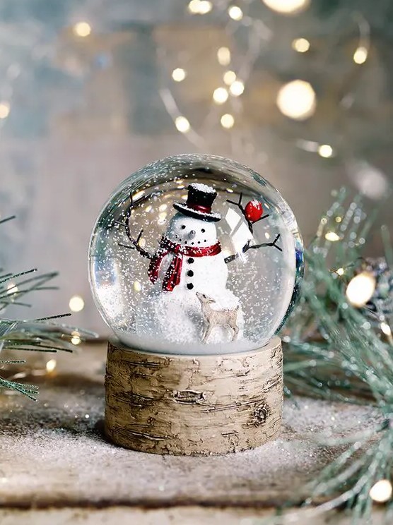 a beautiful snowman snowball with a little deer is a cool decoration or a gift for Christmas