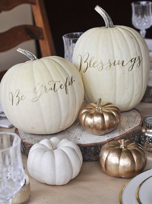 white pumpkins decorated with simple gold calligraphy look very stylish and elegant and are easy to make