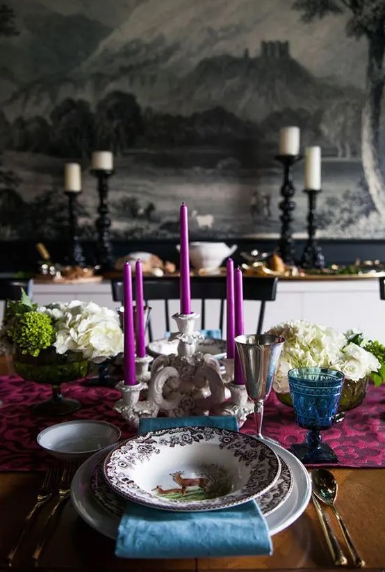 a bright Thanksgiving tablescape done with fuchsia and blue touches plus white hydrangeas and an elegant candelabra