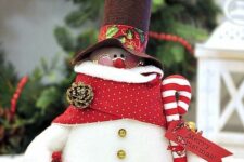 19 a bright snowman decoration with a red wreath, a candy cane, a scarf, a top hat and glasses is amazing for Christmasn