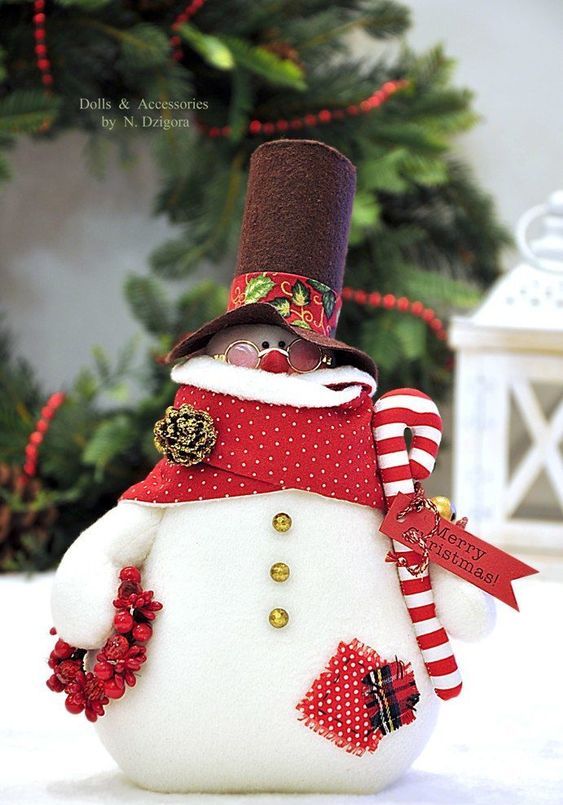a bright snowman decoration with a red wreath, a candy cane, a scarf, a top hat and glasses is amazing for Christmasn