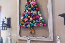 19 a colorful ornament Christmas tree formed right on the wall and highlighted with a vintage frame is a creative idea