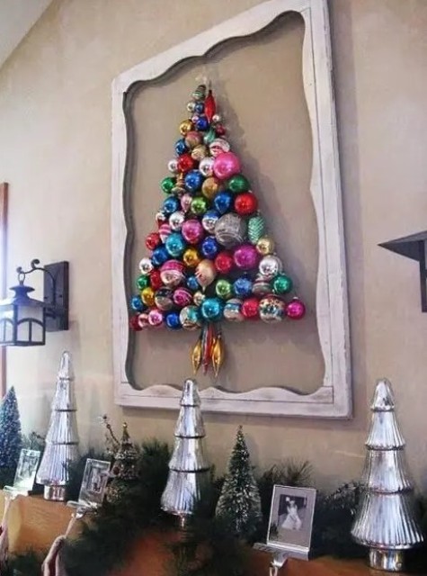 a colorful ornament Christmas tree formed right on the wall and highlighted with a vintage frame is a creative idea