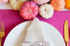 20 a bright Thanksgiving tablescape with a hot pink tablecloth, bold pumpkins and bold blooms, dip dyed napkins