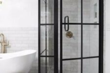 21 a modern black and white bathroom with a shower space with black French doors, patterned and black tiles, a tub and a basket