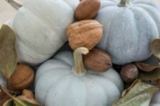 21 a natural centerpiece of a white bowl with milk paint pumpkins, nuts and foliage is great for Thanksgiving
