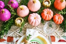 22 a colorful and glam Thanksgiving tablescape with a greenery and macrame runner, white gold rimmed plates, colorful pumpkins