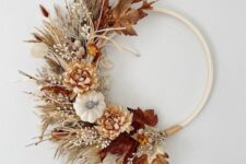 23 a boho Thanksgiving wreath of an embrodiery hoop, with dried grasses, faux blooms and leaves, some twigs and berries