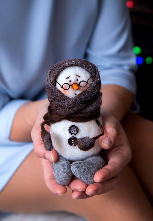 a felt snowman in a scarf, mittens and socks wearing glasses is a great idea for Christmas