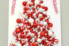 23 a red and white Christmas tree art of various ornaments and a red and white ribbon bow on top