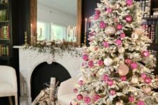 23 a sophisticated flocked Christmas tree decorated with white, blush and pink ornaments and lights and a lit up star topper