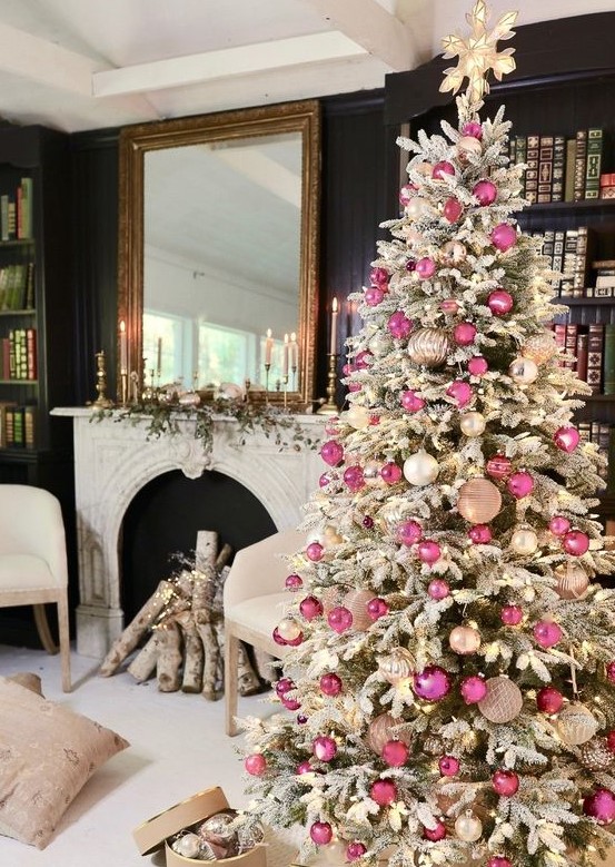 a sophisticated flocked Christmas tree decorated with white, blush and pink ornaments and lights and a lit up star topper