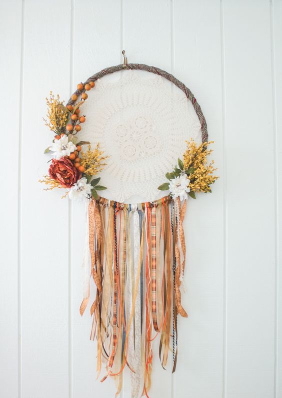 a boho Thanksgiving wreath of an embroidery hoop, bold and white blooms and greenery and fabric ties