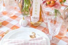 24 a cool blush and orange Thanksgiving tablscape with orange and pink blooms, white pumpkins and gold cutlery