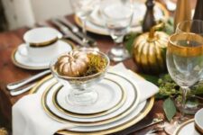 24 a refined Thanksgiving tablescape with gold rimmed plates and glasses plus gilded pumpkins is cool