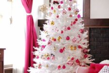 24 a white Christmas tree decorated with light and hot pink and gold ornaments is a stylish and catchy decoration