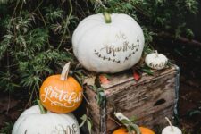 24 an arrangement of white and orange pumpkins with paint and foiling calligraphu is a cool idea for Thanksgiving