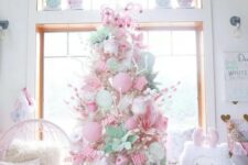 26 a neutral Christmas tree decorated with pink and pastel green ornaments, candy canes, faux blooms and cupcakes is amazing