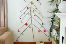 26 a simple wall Christmas tree done with tape and some colorful ornaments attached to the wall